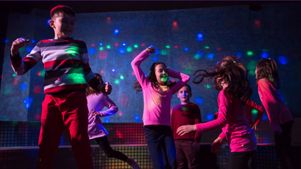 Children dancing in a disco.
