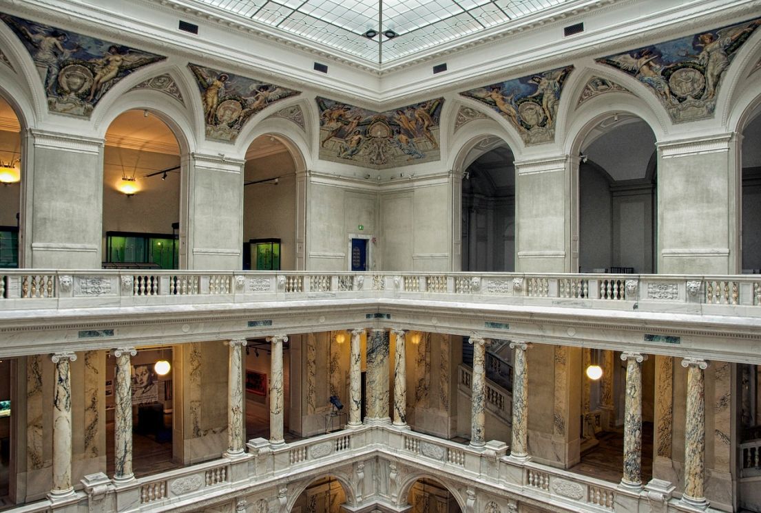 Corner view of ornate colonnaded balconies inside a building's lightwell.