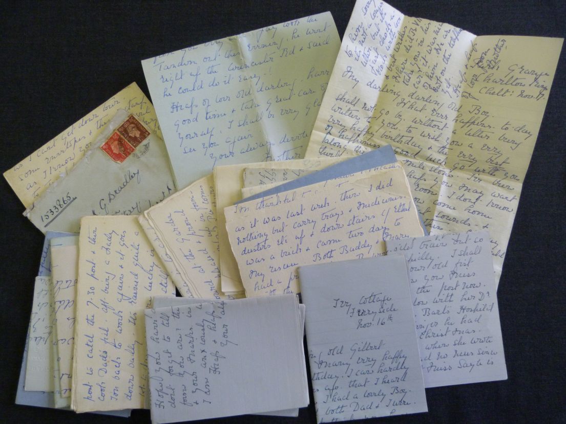 A collection of beautifully handwritten letters in front of black background.