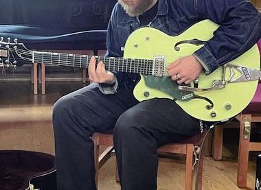 Glen on one of his guitars
