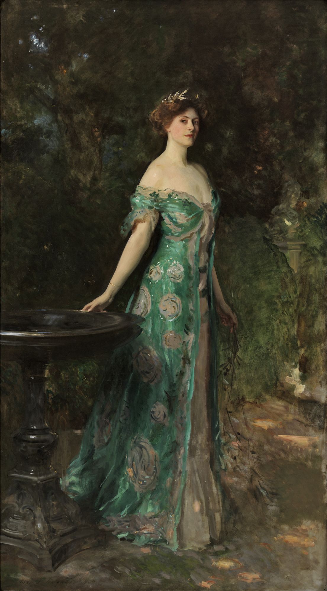 A full length portrait of a women, with a shoulder draped green dress with flowers in a tied up hair. She is depicted standing in a garden.
