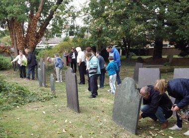 Visitors studying headstones