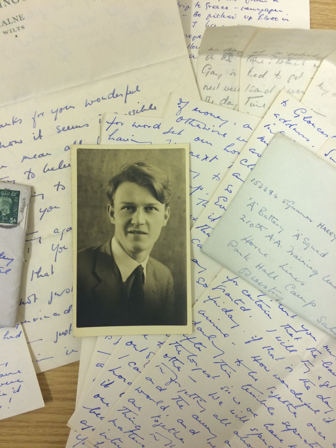 A collection of beautifully handwritten letters along with a black and white photograph headshot of a young man.