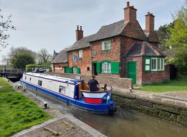 Sandiacre Lock Cottages with a narrowboat going through the lock