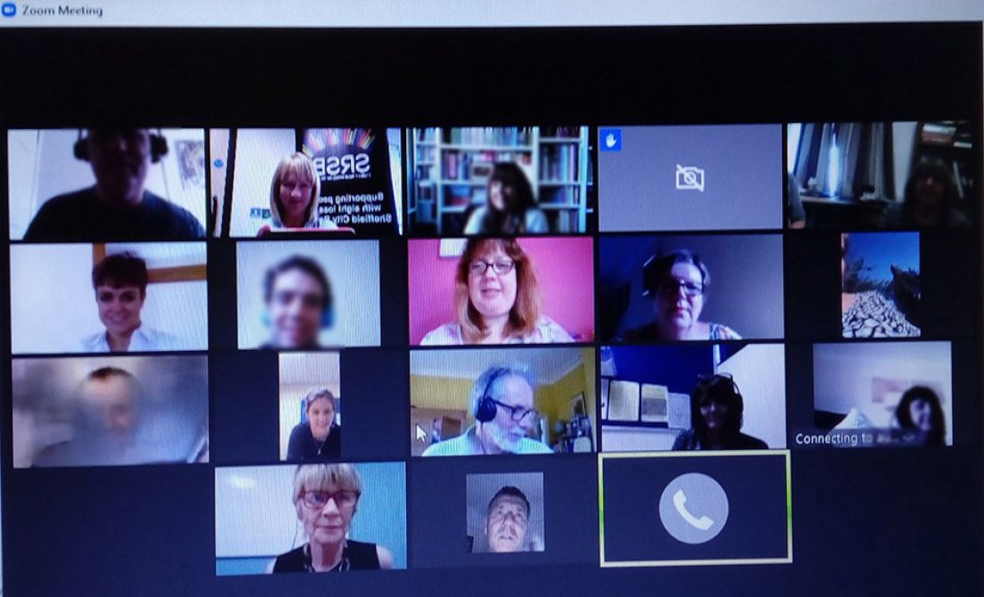 A picture of someone's computed screen - they are on a zoom call in the group view setting, with many faces on the screen.