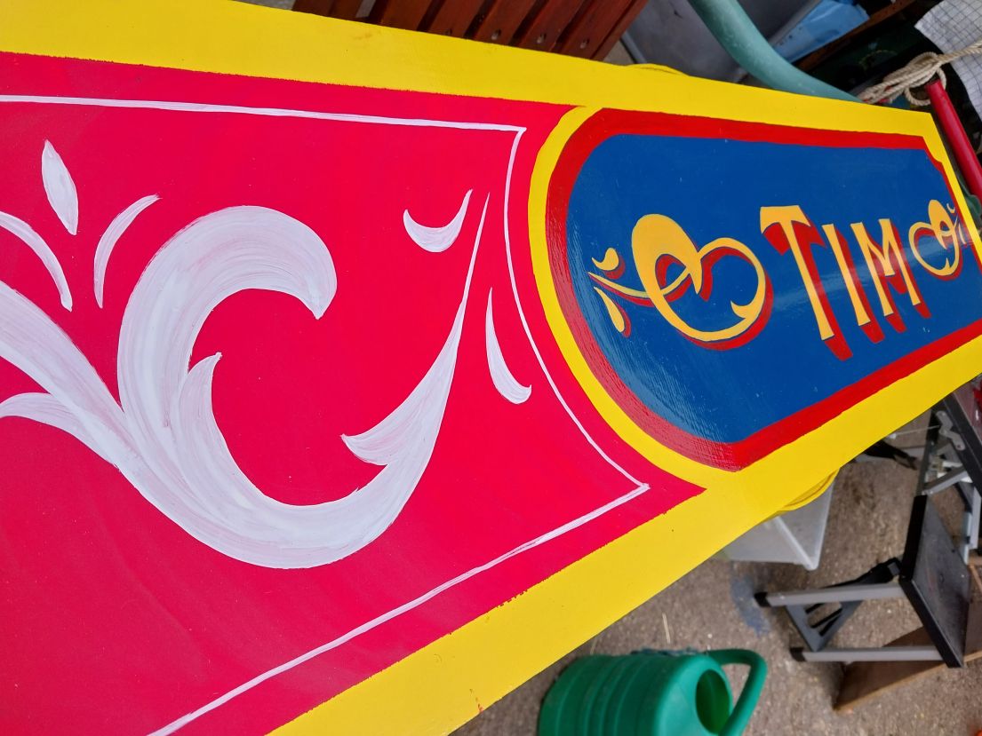 Brightly painted sign with the name 'Tim'