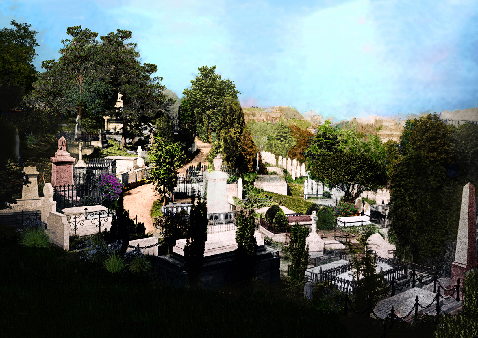 Cemetery with various stone grave markers of different shapes and sizes, amongst green trees.
