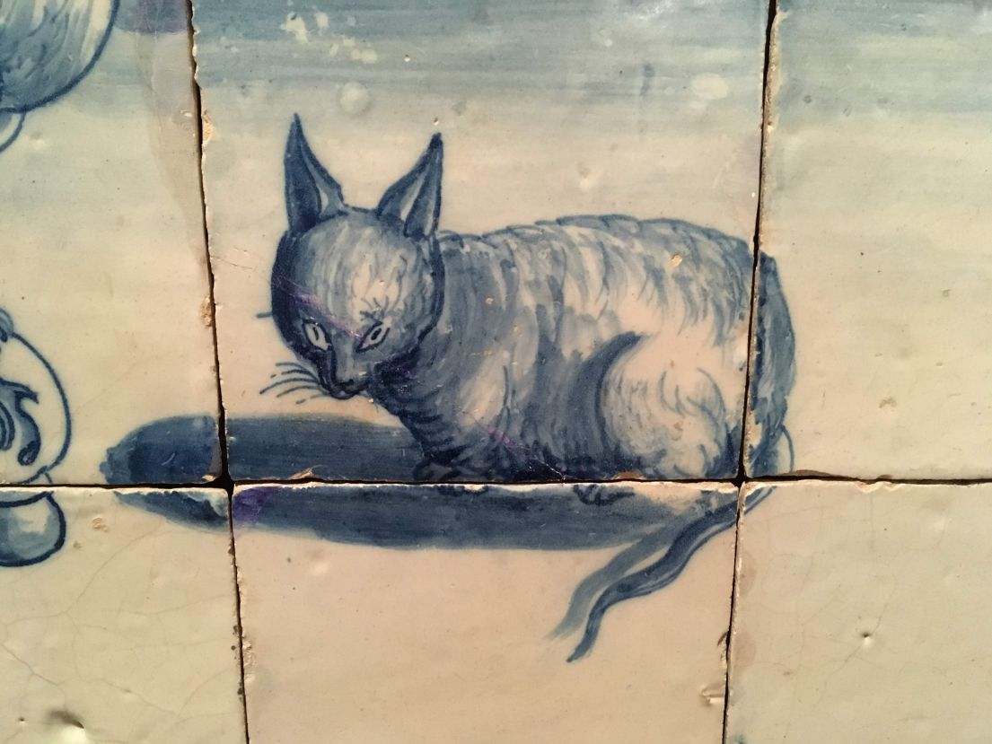 A group of Painted tiles with the design of a cat.