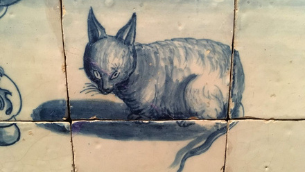 A group of Painted tiles with the design of a cat.