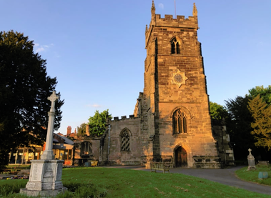 Image of church building with a tower in the sunlight