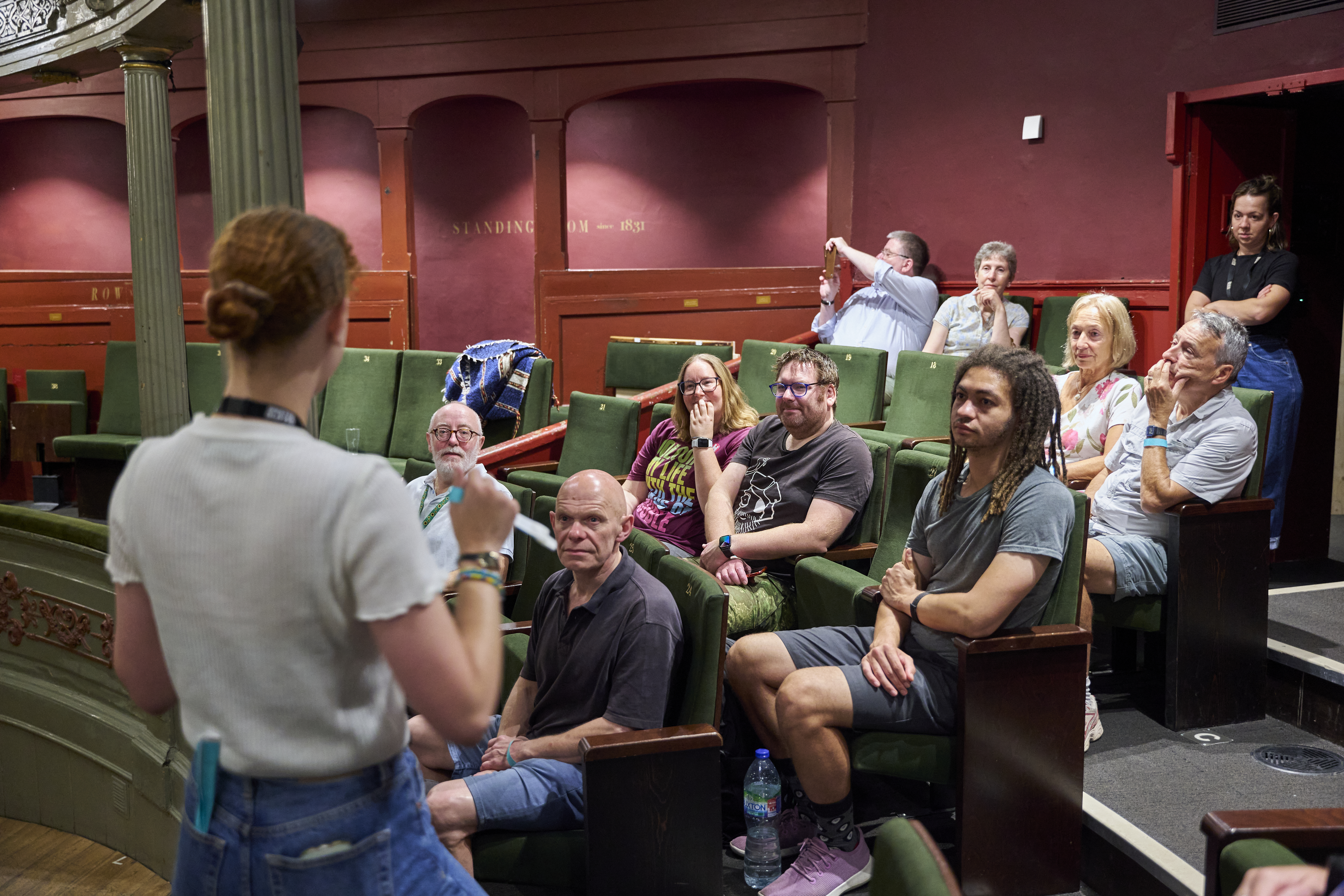 A photograph of people in an auditorium at Bristol Old Vic listening to a tour.