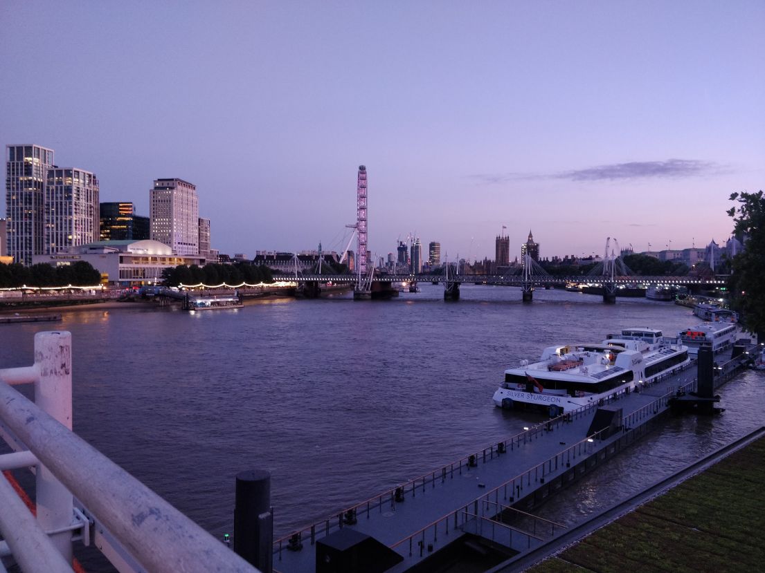 An image taken from waterloo bridge, showing the London skyline at dusk.