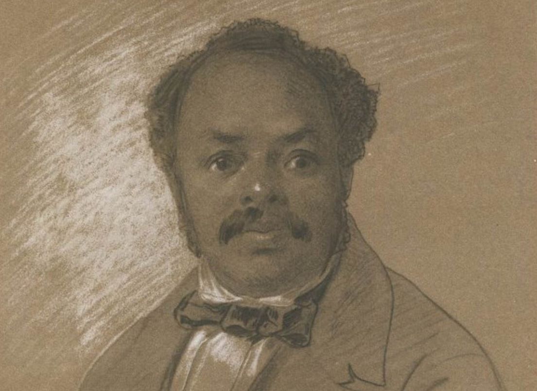 Chalk sketch of a man with a high forehead, dark curly hair and a moustache wearing a bow tie.