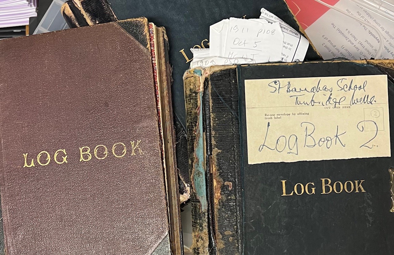 Two small log books with frayed covers.