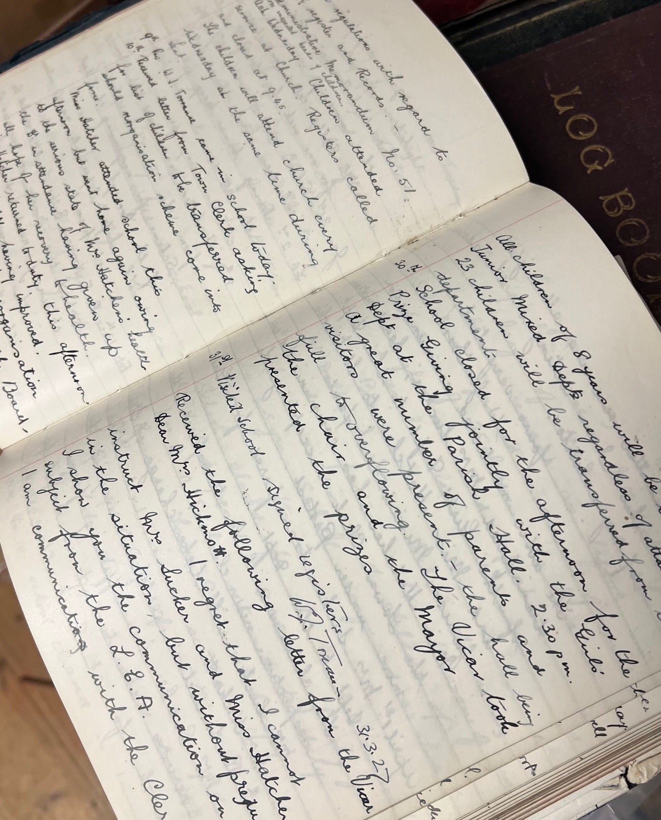 Exercise book laid open, filled with slanted handwriting.