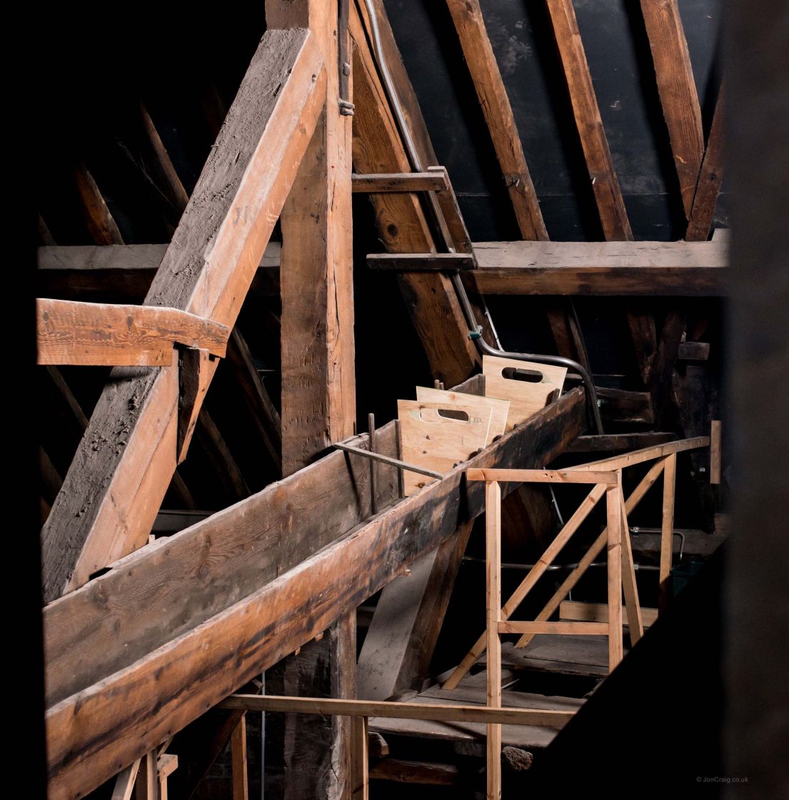 A long wooden contraption in the roof eves of an attic.