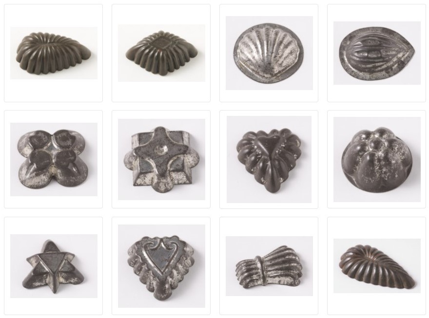 12 small metal moulds of different shapes including a shell and a heart.
