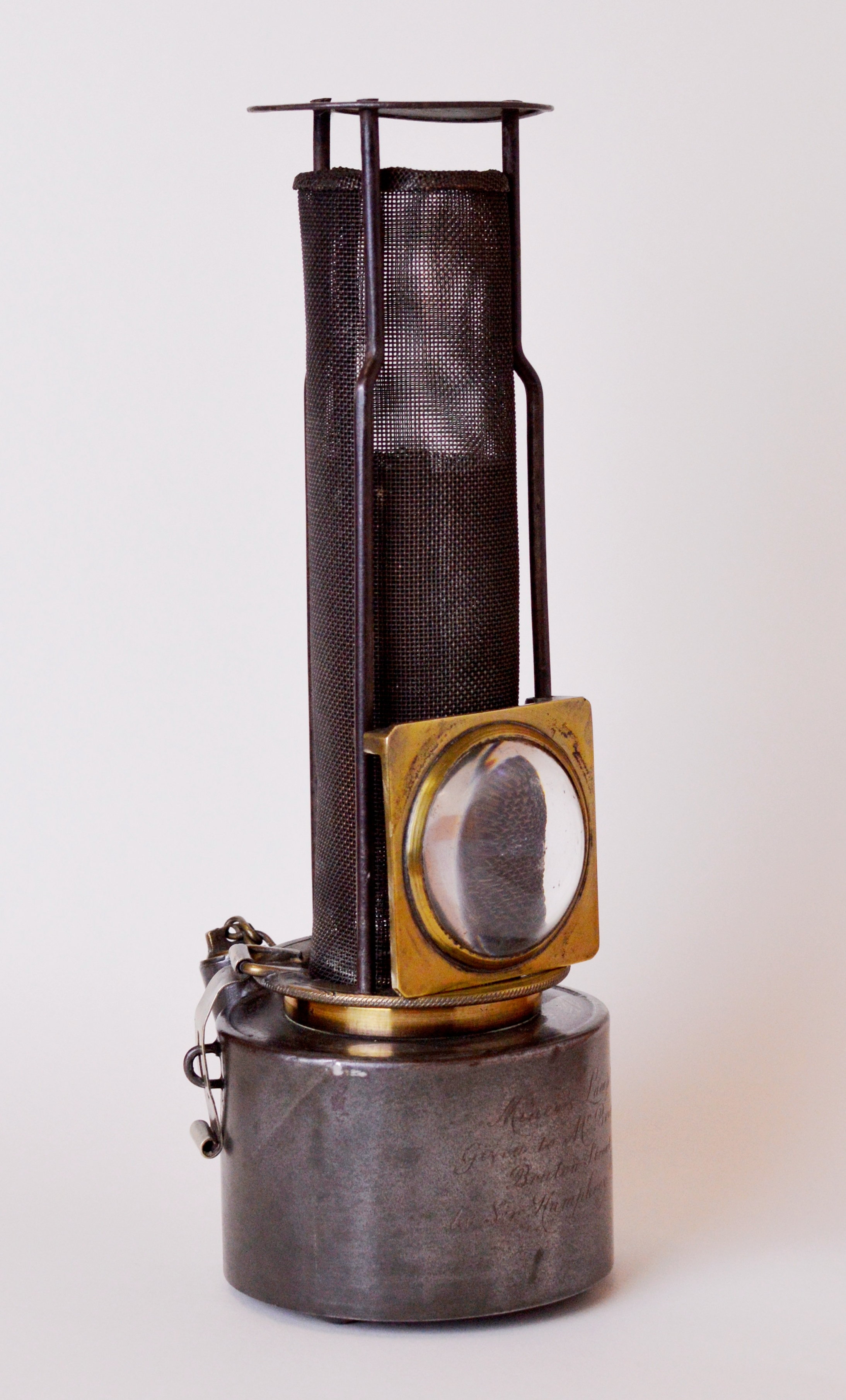 Lamp - looks like a torch stood upright with a circular badge on it.