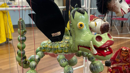 Wooden green dragon puppet.