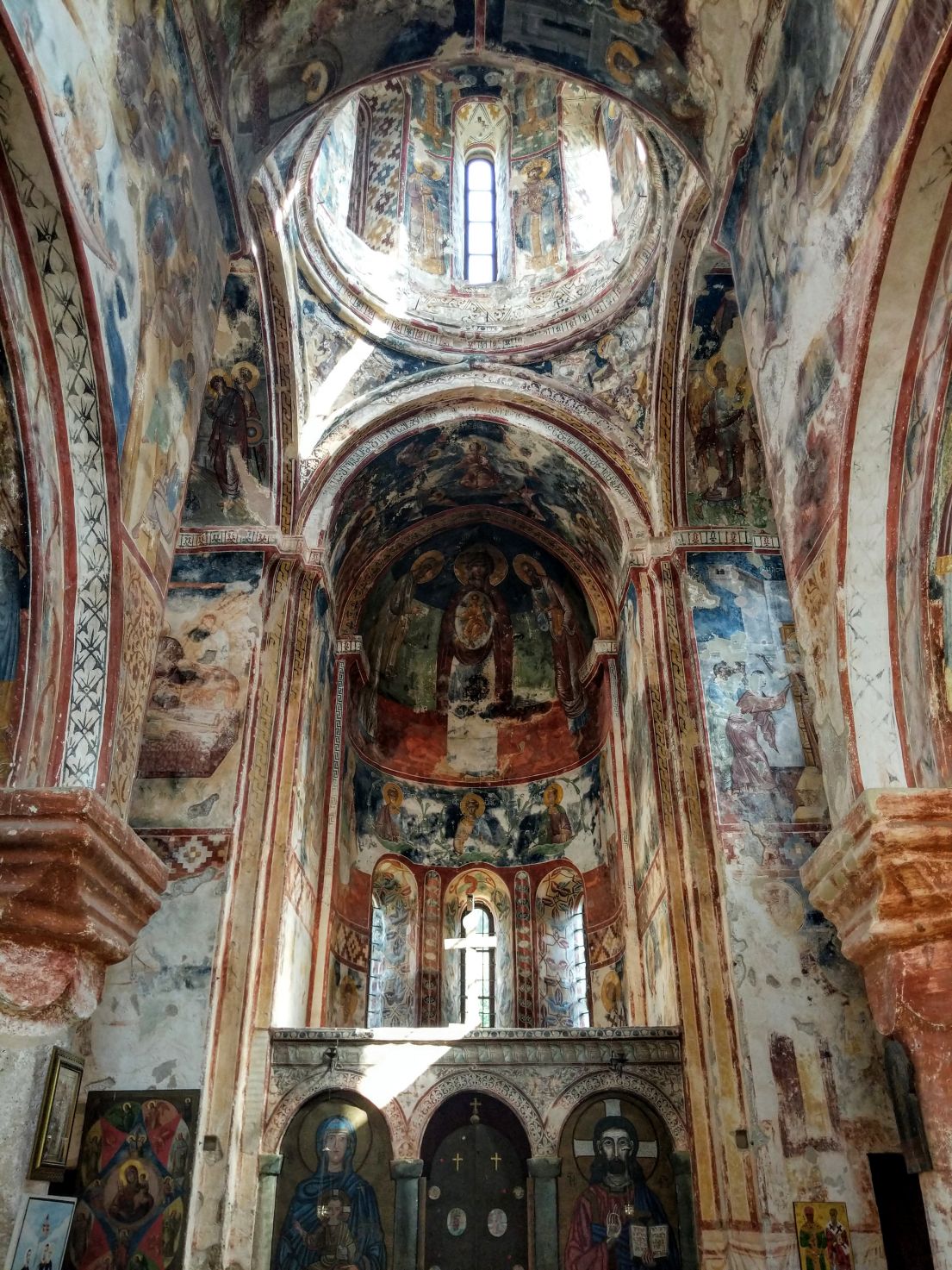 An elaborately decorated interior of a church with religious paintings.