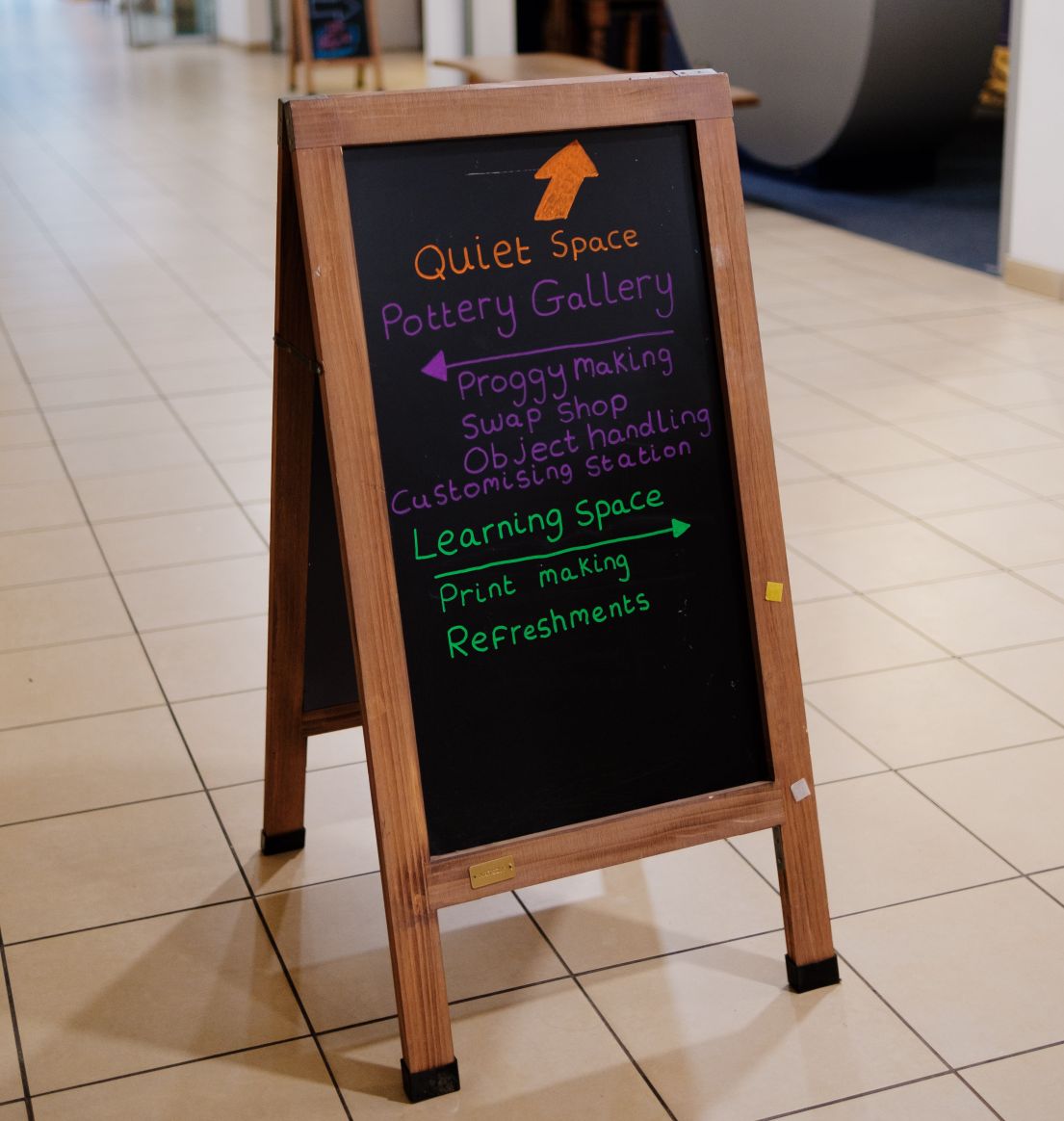 Chalk A board signposting a quiet space, pottery gallery, learning space.