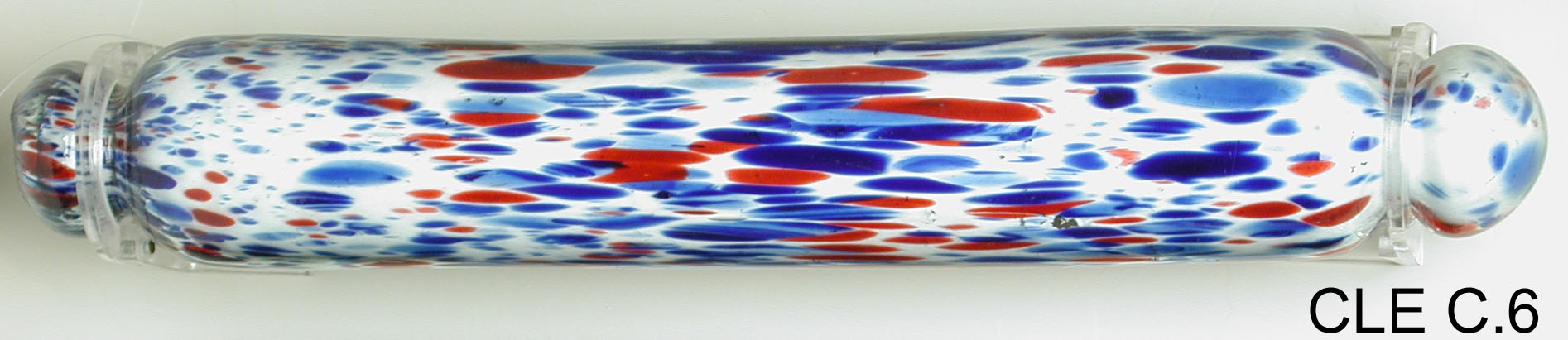 Glass rolling pin flecked with blue and red.