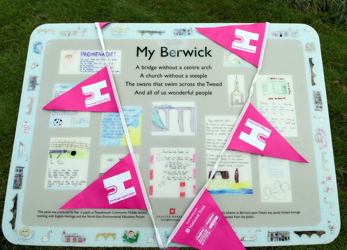 Site interpretation panel covered with festival bunting