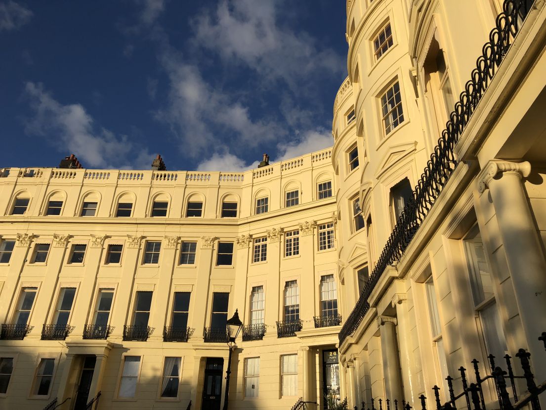  A square of regency style town houses, their white bricks glowing in the sun.