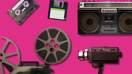 Retro video camera, film reel, floppy disc and cassette tape on a pink background.